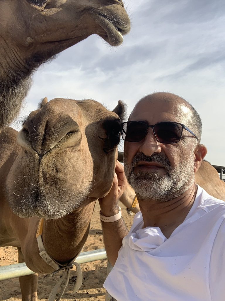 Author with a camel in Alwathba Camel Farm Masakin